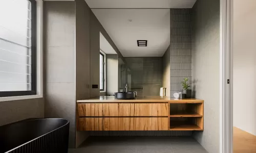 Modern bathroom with a wooden vanity and a large mirror