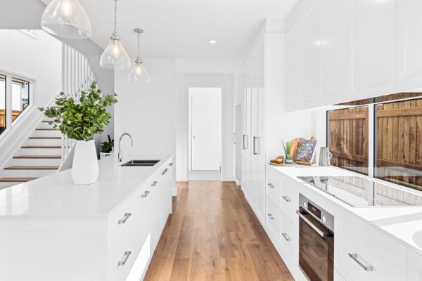 White themed kitchen and wooden floor design