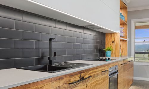 gray bricked wall and kitchen sink