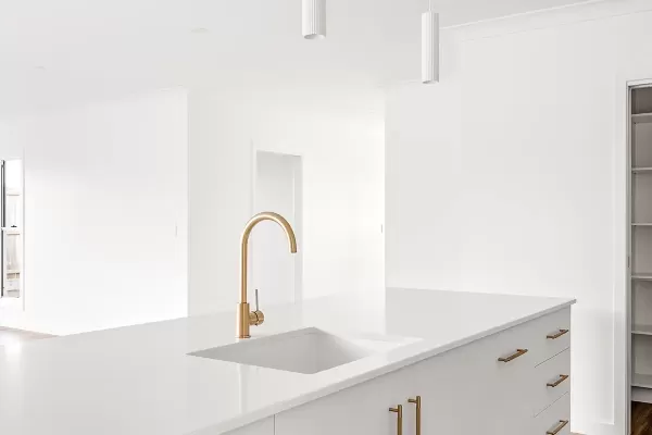 A white kitchen with a sink and cabinets