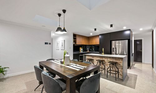 dining area with black chairs and wooden table